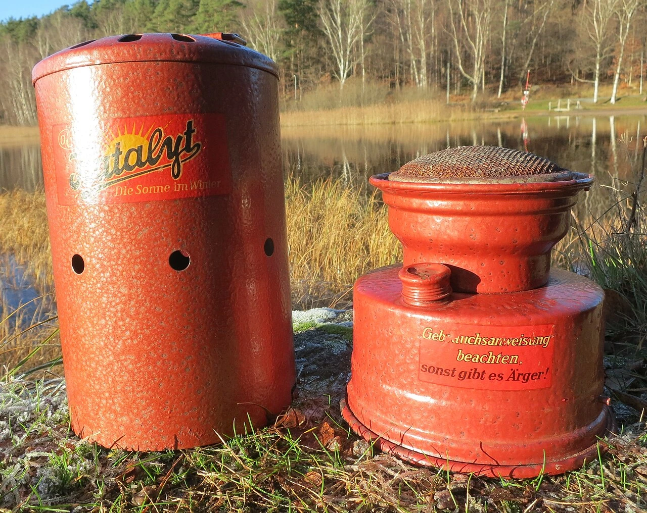 Red vintage catalytic heater by a lakeside