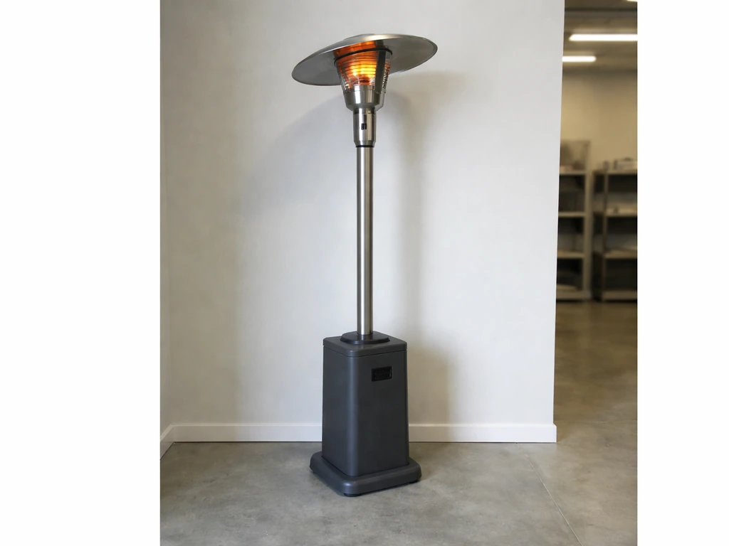 Tall portable radiant heater standing upright with focus on its high-output top head in a minimal indoor space.
